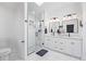 Bathroom features glass shower, white vanity with double sinks, and marble floors at 6062 S Newport St, Centennial, CO 80111