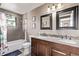 Bathroom with double sinks, granite countertops, mosaic backsplash, and a shower and bathtub at 6062 S Newport St, Centennial, CO 80111