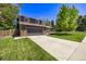 Attractive two-story home showcasing a well-manicured lawn and a spacious driveway leading to a two-car garage at 6062 S Newport St, Centennial, CO 80111