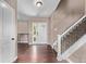 Inviting foyer with hardwood floors, staircase, and natural light streaming through the front door's glass panels at 6062 S Newport St, Centennial, CO 80111