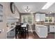 Open kitchen with granite countertops, wooden floors, and dining area at 6062 S Newport St, Centennial, CO 80111