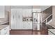 Bright kitchen features stainless steel refrigerator, granite counters, and white cabinets at 6062 S Newport St, Centennial, CO 80111