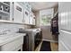 Laundry room with washer, dryer, and a large sink with storage cabinets above at 6062 S Newport St, Centennial, CO 80111