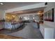 Open basement living room area with stone bar, seating, and natural stone fireplace at 5371 Hazel Rd, Evergreen, CO 80439