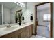 Bathroom boasts dual sinks, a large mirror, and tile floors at 5371 Hazel Rd, Evergreen, CO 80439