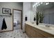 Bathroom boasts dual sinks, a large mirror, and tile floors at 5371 Hazel Rd, Evergreen, CO 80439
