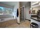 A well-lit bathroom featuring a soaking tub, walk-in shower and large windows at 5371 Hazel Rd, Evergreen, CO 80439