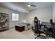 Bedroom featuring carpeted floors, natural light, ceiling fan, and gaming setup at 5371 Hazel Rd, Evergreen, CO 80439