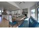 Dining area with a stone fireplace, blue built-in bench, and hardwood floors at 5371 Hazel Rd, Evergreen, CO 80439