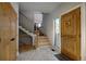 Elegant entryway with a beautiful front door, staircase, and wood flooring at 5371 Hazel Rd, Evergreen, CO 80439