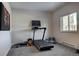 Bright exercise room with natural light, treadmill, and yoga accessories at 5371 Hazel Rd, Evergreen, CO 80439