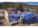 Beautiful home featuring solar panels and a multi-level deck, nestled in a wooded setting at 5371 Hazel Rd, Evergreen, CO 80439