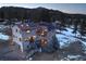 Charming home featuring solar panels, a multi-level deck, and a wooded setting at 5371 Hazel Rd, Evergreen, CO 80439