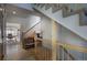 A naturally lit hallway with hardwood floors, staircase, and open view to an office at 5371 Hazel Rd, Evergreen, CO 80439