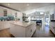 Bright kitchen with white cabinets, an island with marble countertops, and a tiled backsplash at 5371 Hazel Rd, Evergreen, CO 80439
