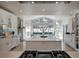 Bright and airy kitchen featuring a large island, stone accents, and scenic views at 5371 Hazel Rd, Evergreen, CO 80439