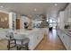 Open kitchen with a large island, white cabinets, and a stone fireplace at 5371 Hazel Rd, Evergreen, CO 80439