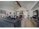 Bright living room boasts stone fireplace, vaulted ceiling, and hardwood floors at 5371 Hazel Rd, Evergreen, CO 80439