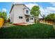 Well maintained lawn with a cozy wooden deck, complimented by a covered patio and lush green grass at 5238 S Jericho Way, Centennial, CO 80015