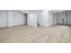 This newly finished basement features durable plank flooring and neutral-colored walls at 5238 S Jericho Way, Centennial, CO 80015