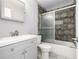 This bathroom features gray tiled walls, a bathtub with sliding glass doors, and a gray vanity at 5238 S Jericho Way, Centennial, CO 80015