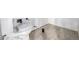 Unfinished bathroom showcases new flooring, with exposed plumbing and wall fixtures in progress at 5238 S Jericho Way, Centennial, CO 80015