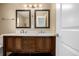 Double vanity bathroom with framed mirrors and dark cabinets at 5238 S Jericho Way, Centennial, CO 80015