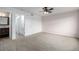 Spacious bedroom with carpeted floor, ceiling fan, and multiple doors at 5238 S Jericho Way, Centennial, CO 80015