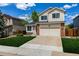 Charming two story home featuring a well maintained lawn, driveway, and attached two-car garage at 5238 S Jericho Way, Centennial, CO 80015
