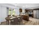 Modern kitchen with stainless steel appliances, dark wood cabinetry, and an adjacent dining area is perfect for meals at 5238 S Jericho Way, Centennial, CO 80015