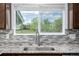 Beautiful kitchen sink with a granite countertop and window view to the backyard at 5238 S Jericho Way, Centennial, CO 80015