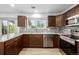 Well-equipped kitchen with granite countertops, stainless steel appliances, and tile backsplash is ready for cooking at 5238 S Jericho Way, Centennial, CO 80015