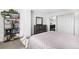 Spacious bedroom with walk-in closet, dresser, and bookshelf creating a comfortable and organized space at 550 E 12Th Ave # 1203, Denver, CO 80203