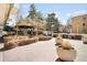 Beautiful courtyard featuring an outdoor cooking area and gazebo with mature trees and greenery at 550 E 12Th Ave # 1203, Denver, CO 80203