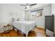 Bedroom featuring hardwood floors, a large window, and minimalist decor, perfect for relaxation at 9325 Meade St, Westminster, CO 80031