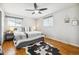 Bright bedroom featuring hardwood floors, a ceiling fan, and a large bed with stylish accents at 9325 Meade St, Westminster, CO 80031