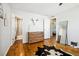 Spacious bedroom with hardwood floors, an adjacent bathroom, and a decorative mirror at 9325 Meade St, Westminster, CO 80031