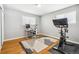 Functional home office with a modern desk, ergonomic chair, and a stationary exercise bike at 9325 Meade St, Westminster, CO 80031