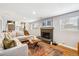 Inviting living room with a stylish fireplace, wood floors, and a comfortable sectional sofa at 9325 Meade St, Westminster, CO 80031