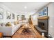 Comfortable living room with a modern fireplace, wood floors, and a cozy sectional sofa at 9325 Meade St, Westminster, CO 80031