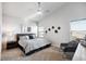 Bright bedroom with a ceiling fan, chair, carpeted floor, and modern decor at 98 Chipeta Way, Lochbuie, CO 80603