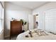 Comfortable bedroom featuring a dresser and an open door leading to other parts of the home at 98 Chipeta Way, Lochbuie, CO 80603