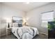 Well-lit bedroom with a cozy bed and bedside tables at 98 Chipeta Way, Lochbuie, CO 80603