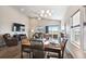 Bright dining area featuring a modern chandelier and sliding glass doors to the outside deck at 98 Chipeta Way, Lochbuie, CO 80603