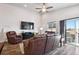 Cozy living room offers a vaulted ceiling, a ceiling fan, and a leather furniture set at 98 Chipeta Way, Lochbuie, CO 80603