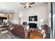 Bright living room featuring a large TV and ceiling fan near the dining and kitchen area at 98 Chipeta Way, Lochbuie, CO 80603