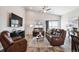 Comfortable living room featuring vaulted ceilings, ceiling fan, and a leather furniture set at 98 Chipeta Way, Lochbuie, CO 80603