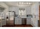 Bright kitchen with white cabinets and stainless steel appliances at 1475 Monaco Pkwy, Denver, CO 80220