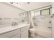 Bright bathroom features marble tile, large mirror, updated vanity and shower-tub combination at 12368 W Nevada Pl # 206, Lakewood, CO 80228