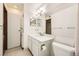 This bathroom has a tile floor, a large mirror, and a stacked washer-dryer to the side at 12368 W Nevada Pl # 206, Lakewood, CO 80228
